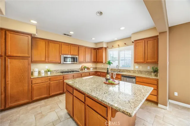 a kitchen with stainless steel appliances granite countertop a refrigerator and stove
