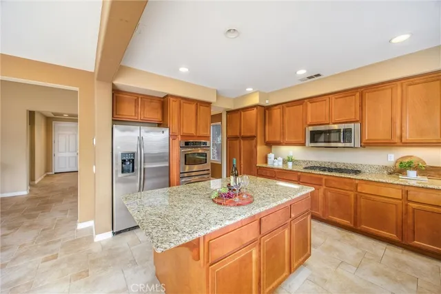 a view of an empty room with a window and fire place