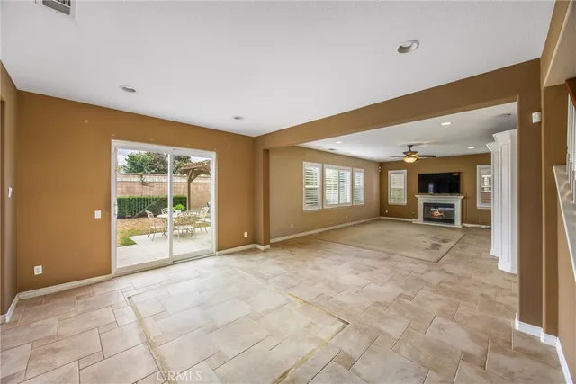 a view of a kitchen with kitchen island granite countertop a sink and a refrigerator