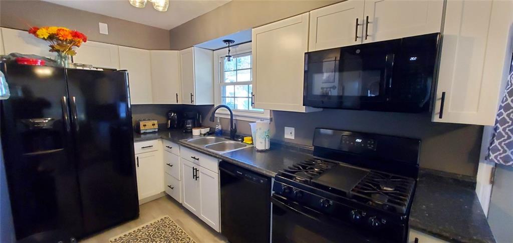 324 West Butler Street Mercer, PA 16137 - Photo 2 of 23 a kitchen with a refrigerator and a stove top oven