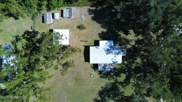 an aerial view of a house with a yard