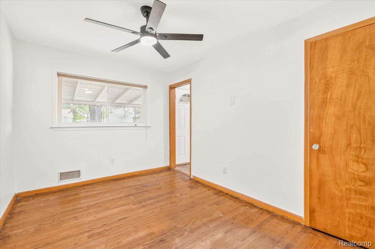 11802 Columbia Street Redford, MI 48239 - Photo 13 of 39 Bedroom 1 with Original Hardwood Floors in good condition, Vinyl Replacement Windows, and a New Ceiling Fan.