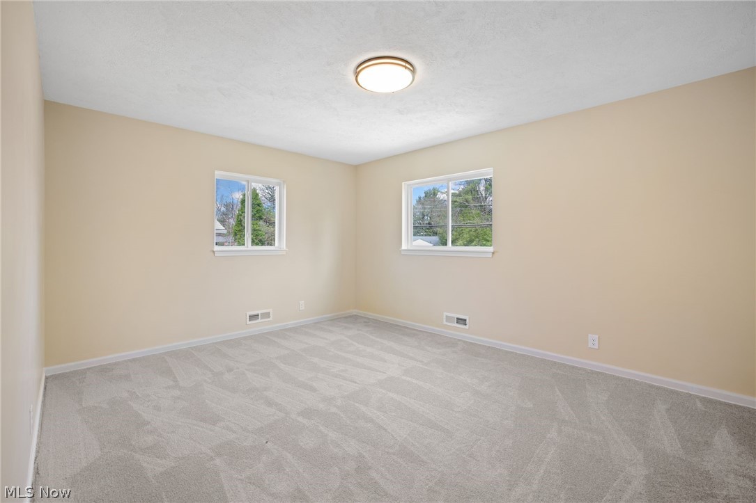 154 Winchester Road Akron, OH 44333 - Photo 20 of 26 Spare room featuring light colored carpet and plenty of natural light