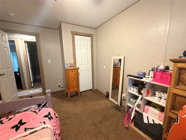 a bedroom with bed and a mirror