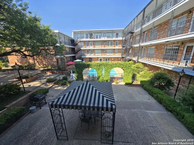 a view of a balcony with sitting area