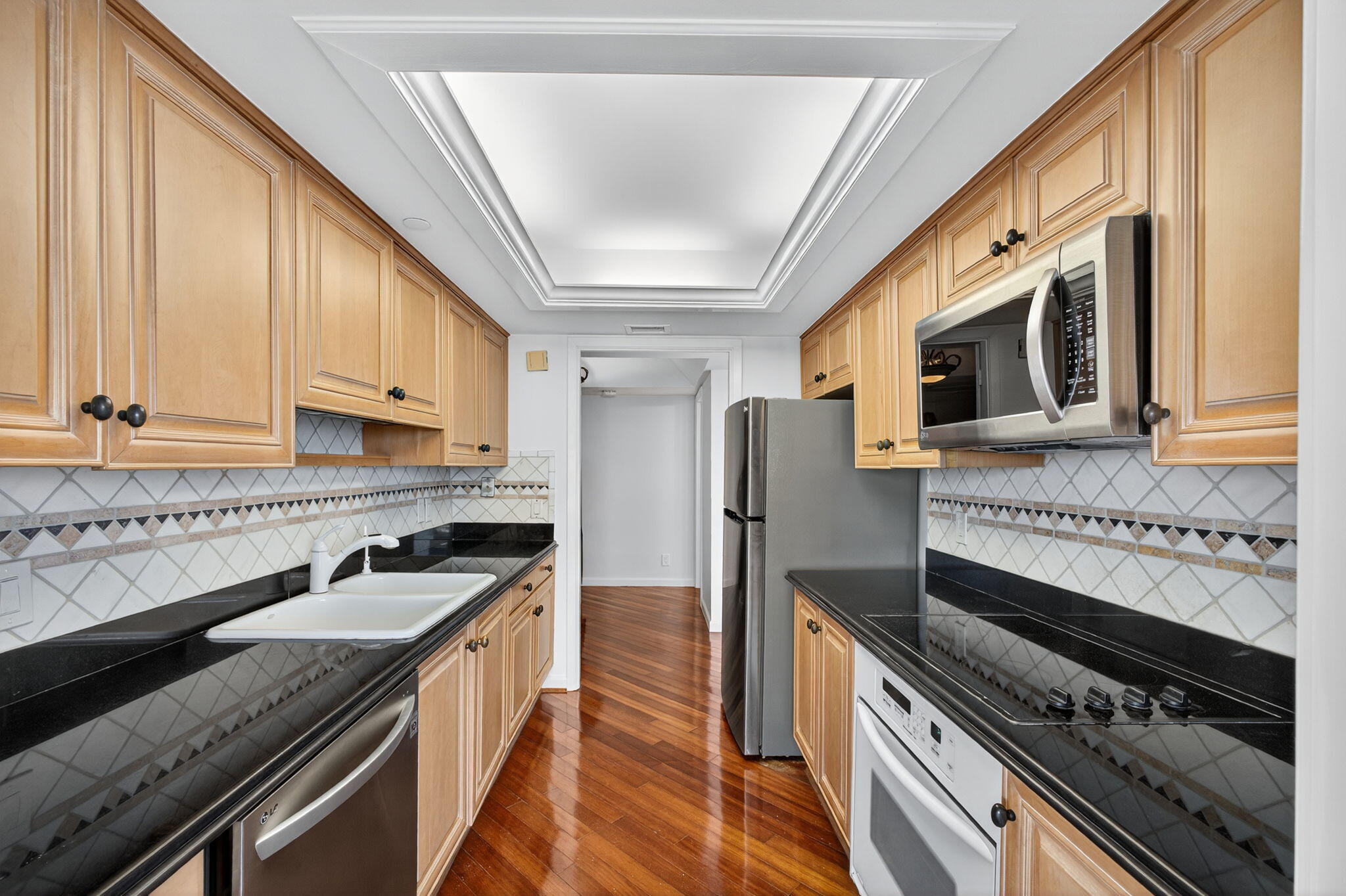 5280 North Ocean Drive, Unit 14D Riviera Beach, FL 33404 - Photo 12 of 55 a kitchen with stainless steel appliances a stove a sink and a refrigerator