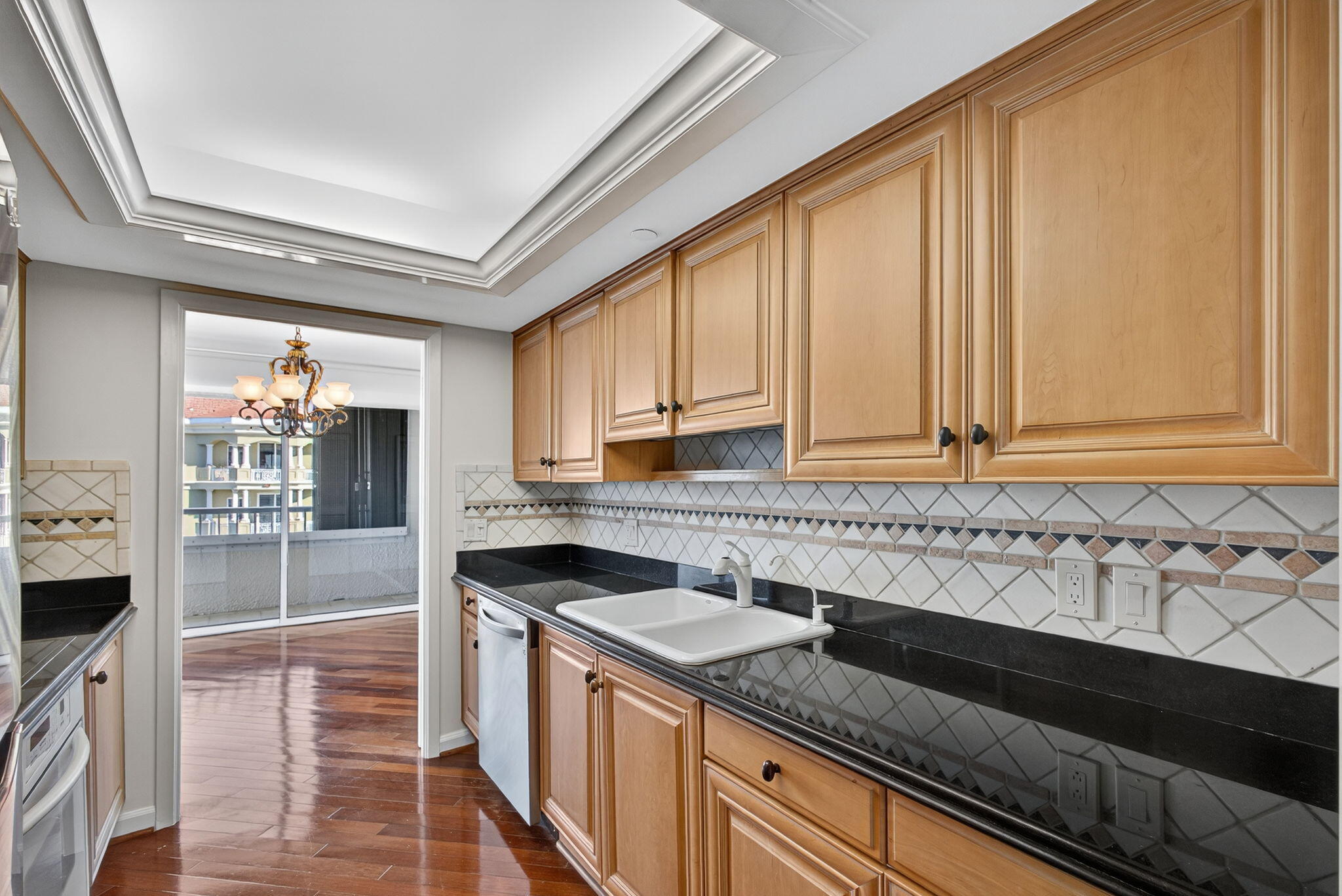 5280 North Ocean Drive, Unit 14D Riviera Beach, FL 33404 - Photo 13 of 55 a kitchen with granite countertop a sink and a stove