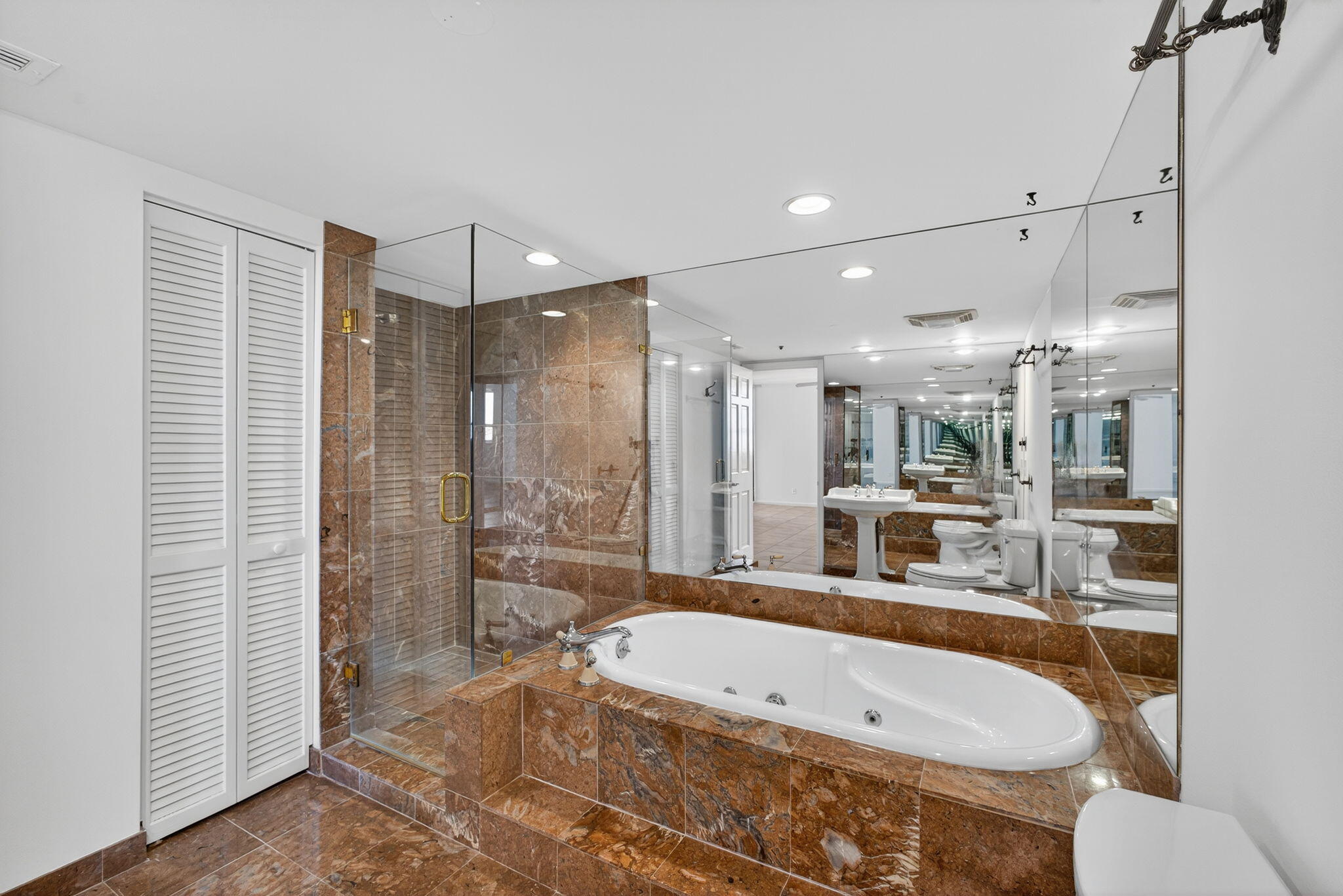 5280 North Ocean Drive, Unit 14D Riviera Beach, FL 33404 - Photo 17 of 55 a large tub sitting in a bathroom near a sink