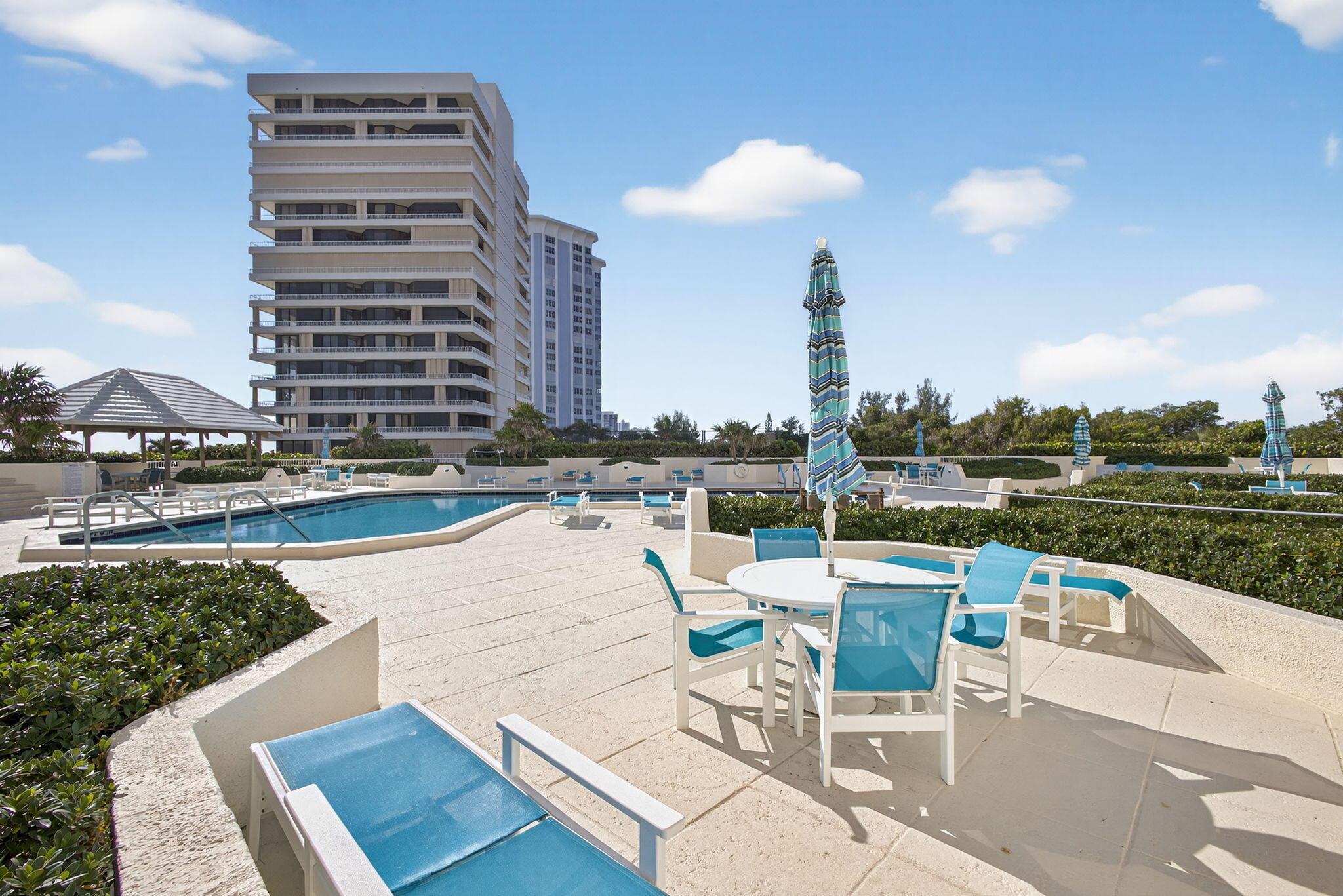 5280 North Ocean Drive, Unit 14D Riviera Beach, FL 33404 - Photo 29 of 55 a view of a swimming pool with a lounge chairs
