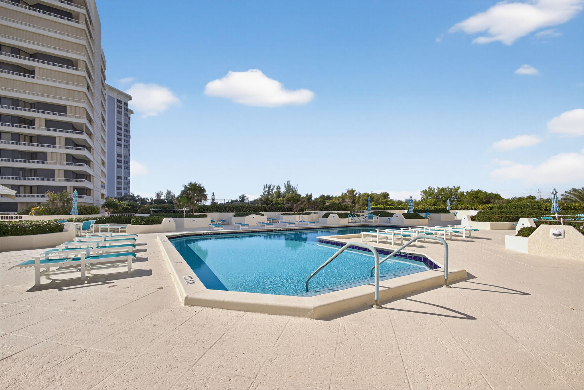 5280 North Ocean Drive, Unit 14D Riviera Beach, FL 33404 - Photo 30 of 55 a view of a swimming pool with a lounge chair