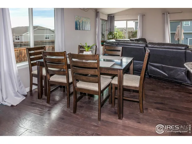 a dining room with furniture and wooden floor