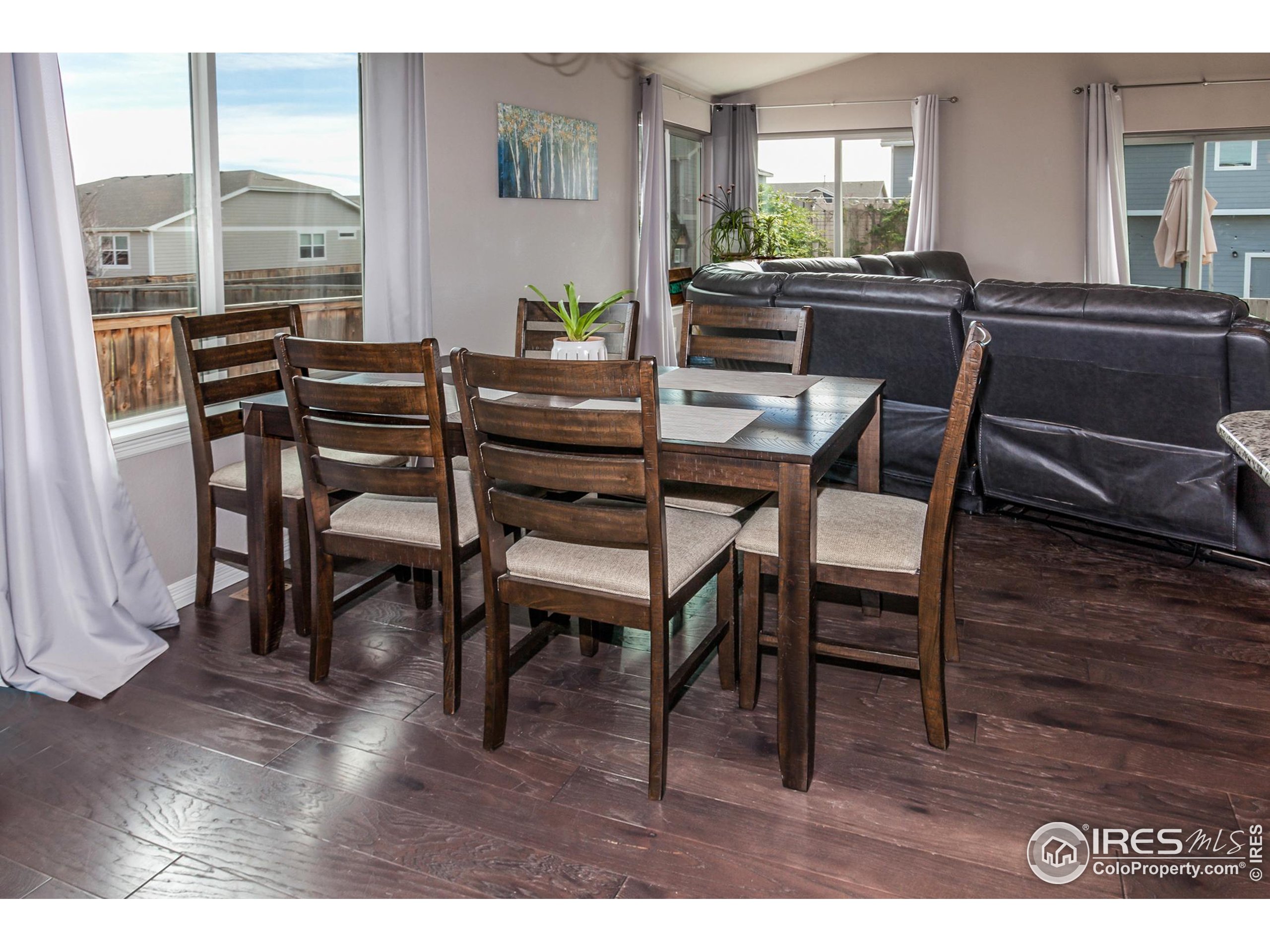 1297 Wild Basin Road Severance, CO 80550 - Photo 11 of 44 a dining room with furniture and wooden floor