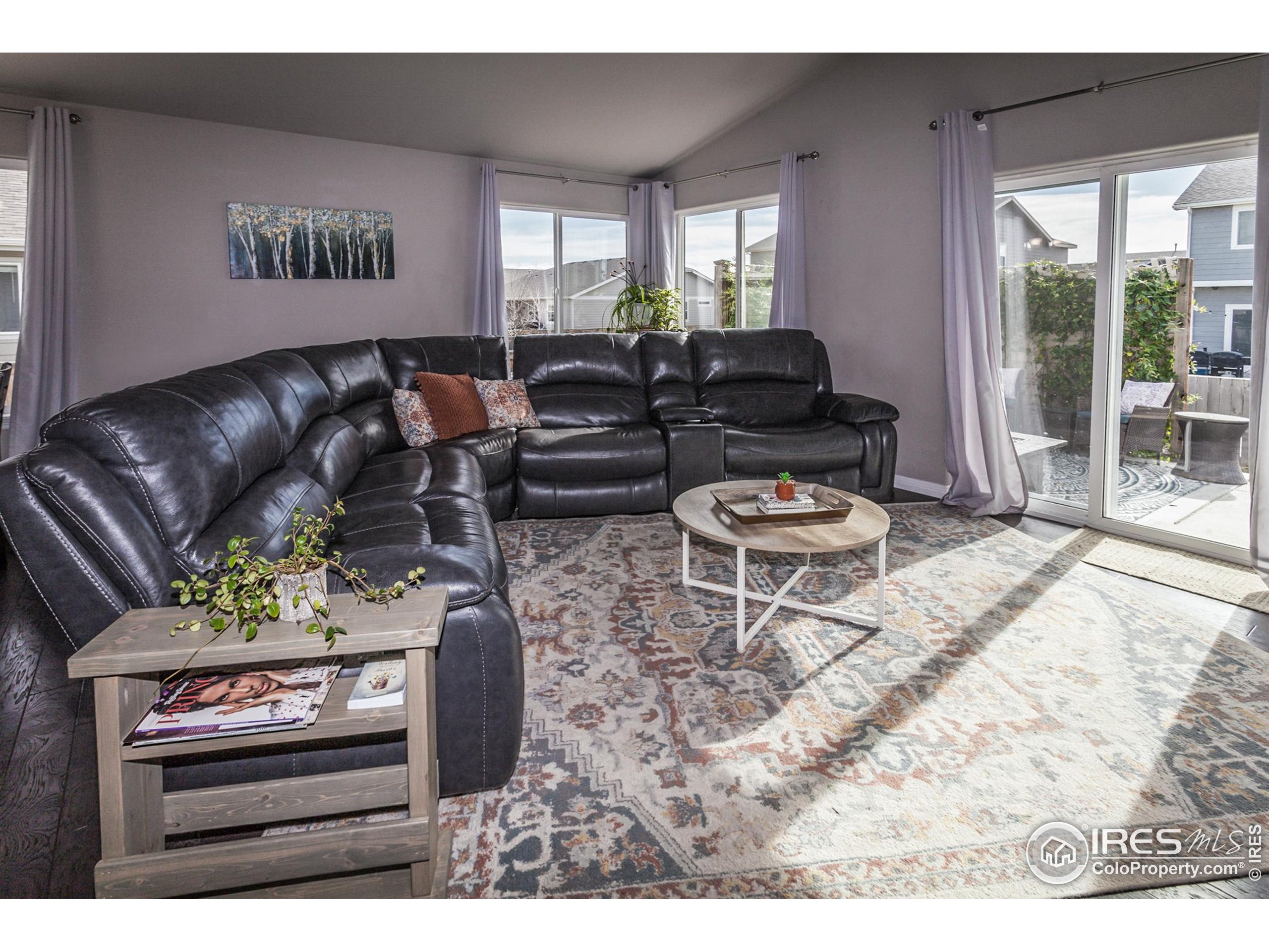 1297 Wild Basin Road Severance, CO 80550 - Photo 12 of 44 a living room with furniture a window and a flat screen tv
