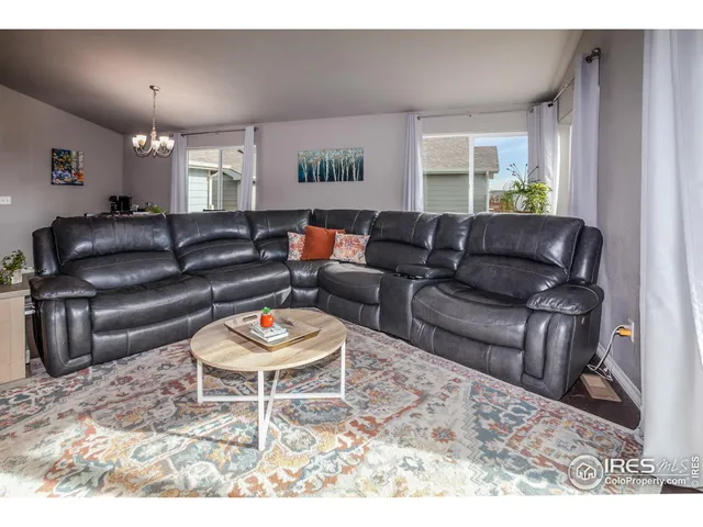 a living room with furniture and a rug