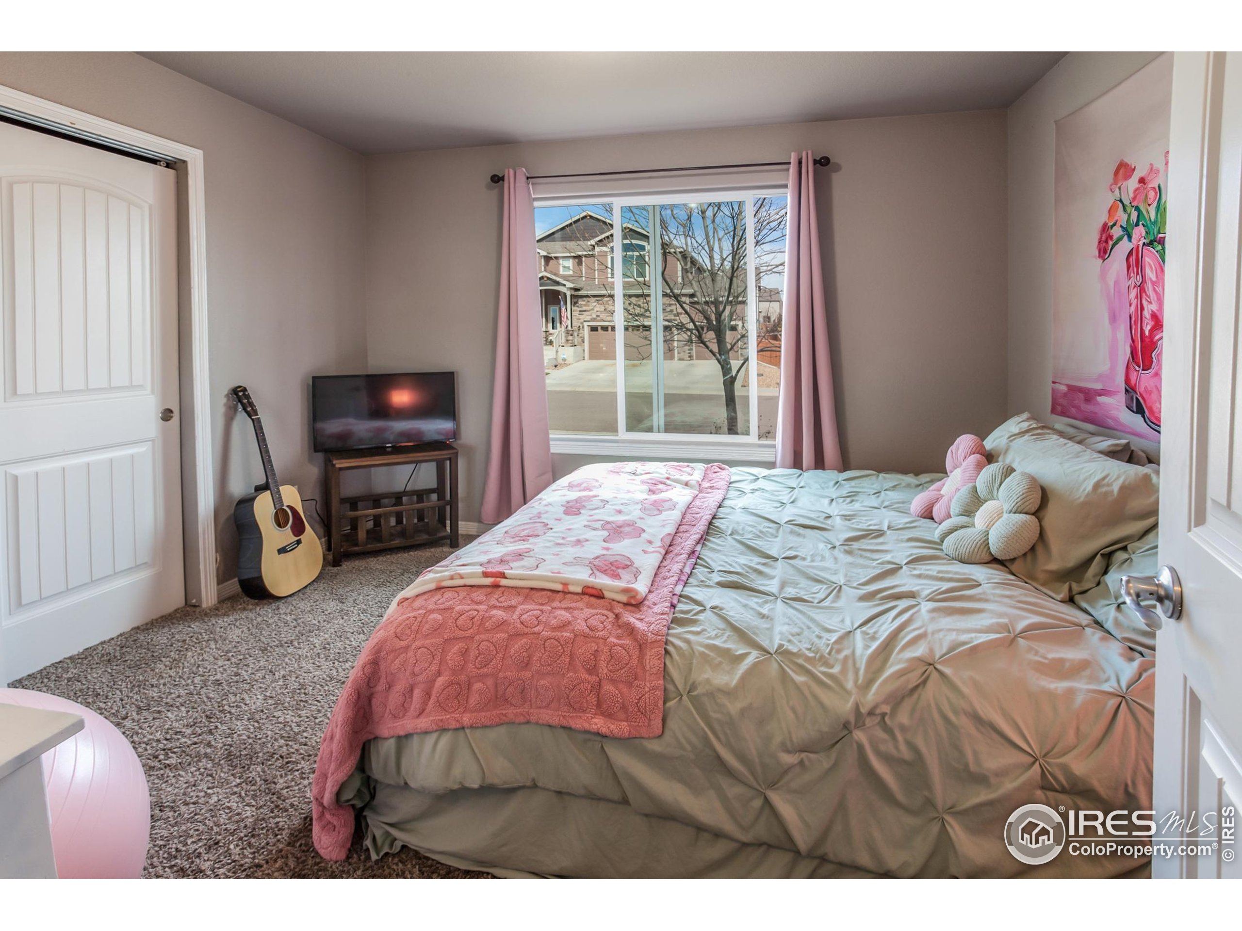 1297 Wild Basin Road Severance, CO 80550 - Photo 14 of 44 a bedroom with a bed next to a window
