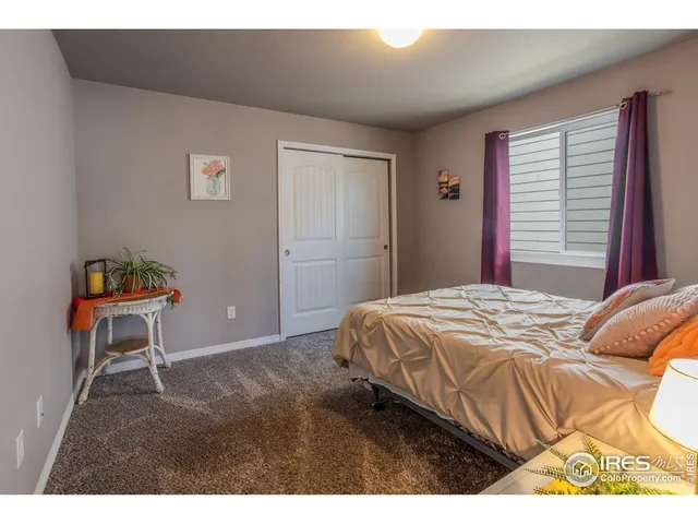 a bedroom with a bed and a table in it