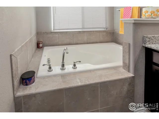 a bathroom with a tub sink and vanity