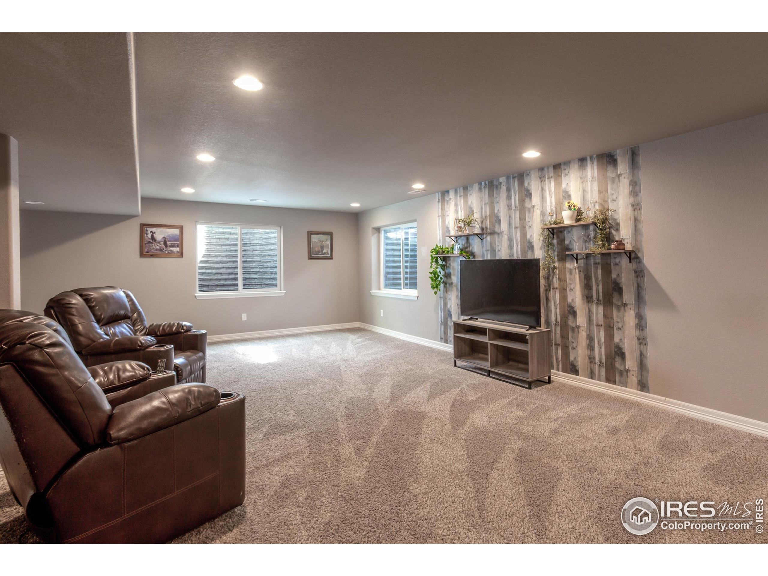 1297 Wild Basin Road Severance, CO 80550 - Photo 28 of 44 a living room with furniture and a flat screen tv