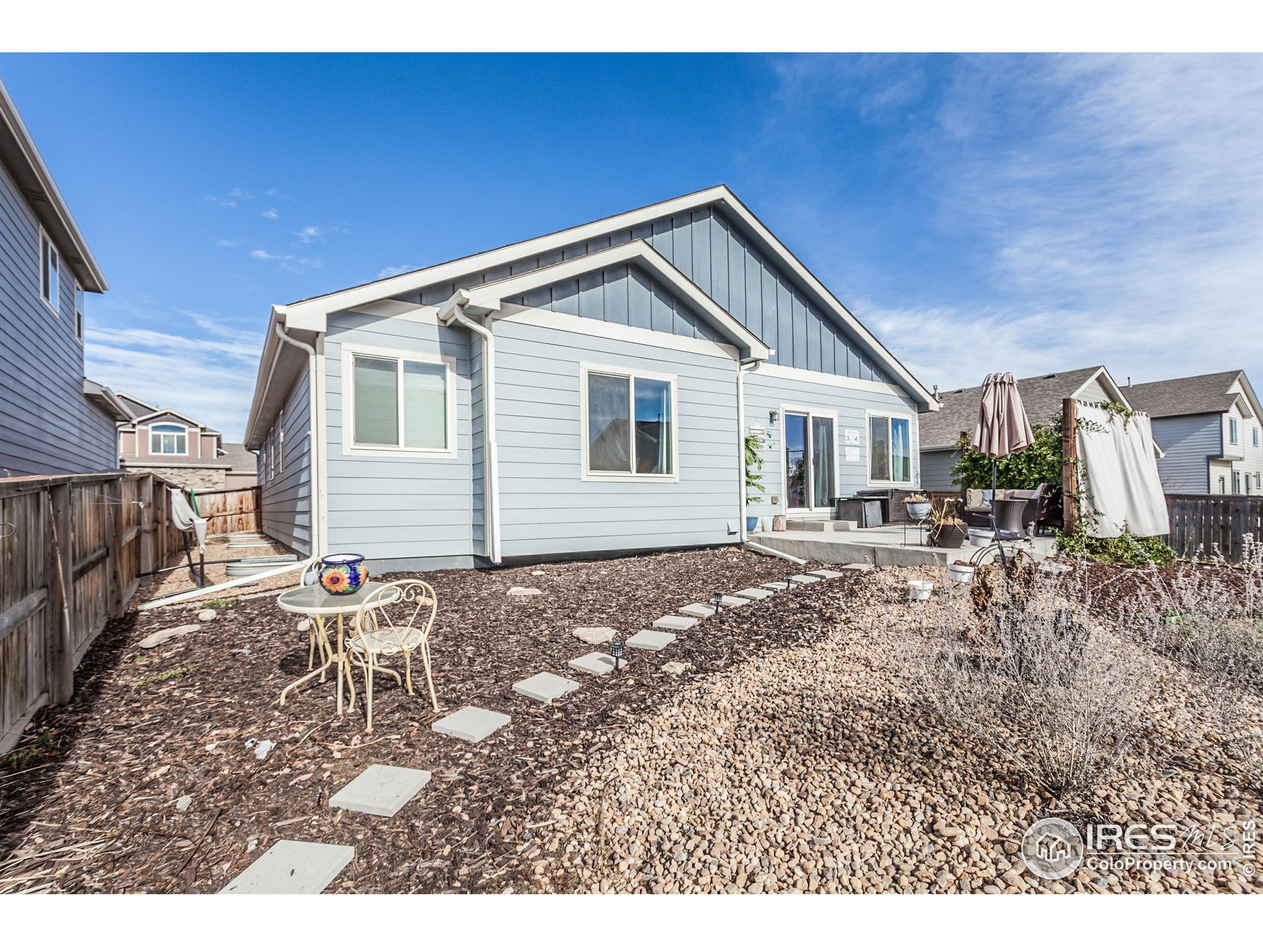 1297 Wild Basin Road Severance, CO 80550 - Photo 39 of 44 a backyard of a house with table and chairs