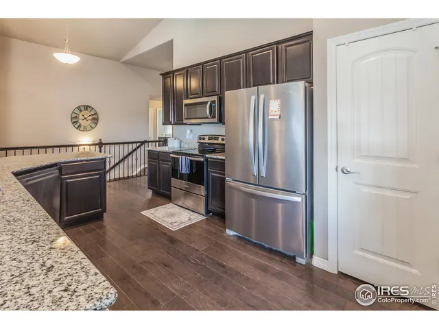 a kitchen with stainless steel appliances a refrigerator and a stove top oven