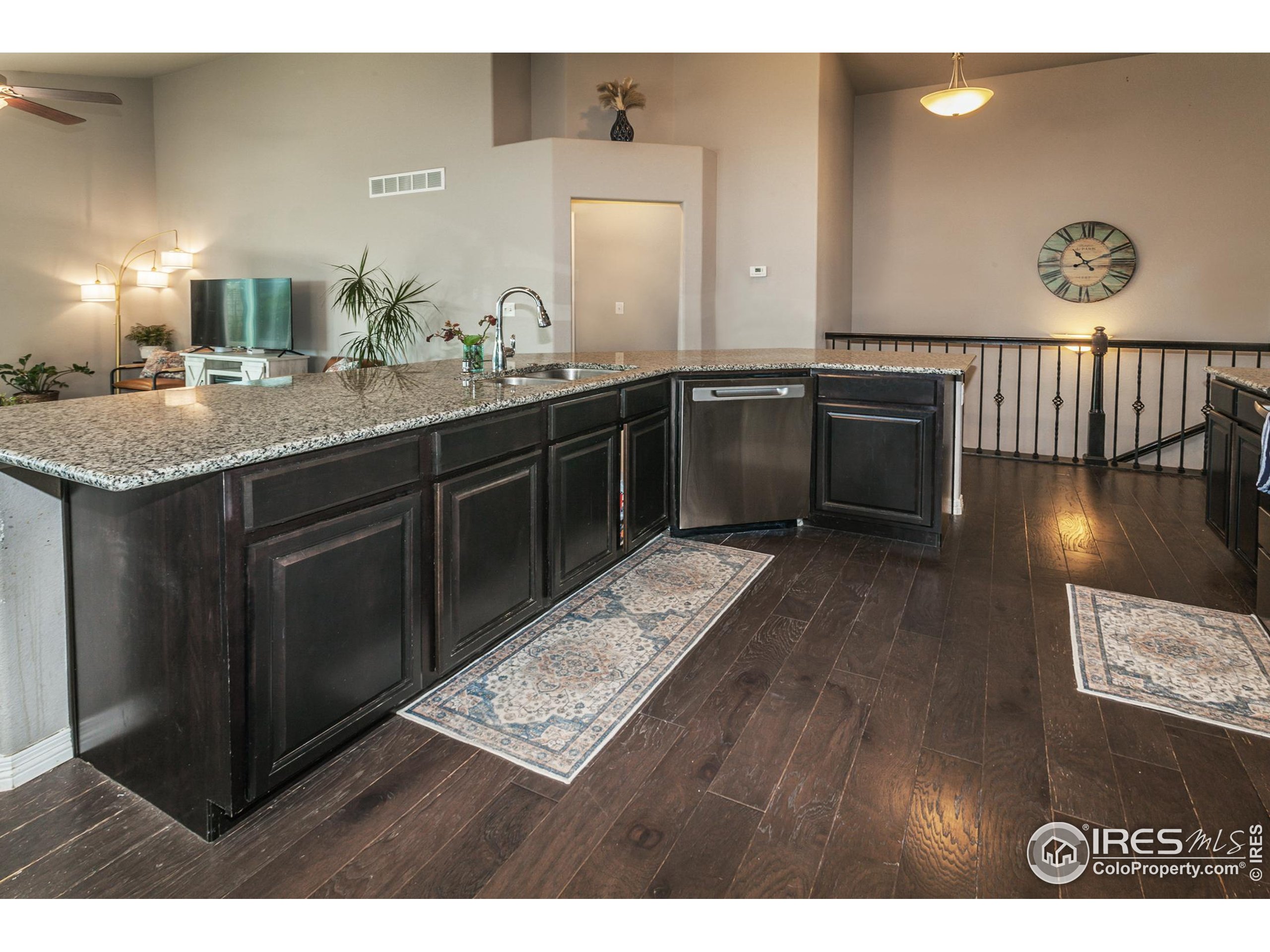 1297 Wild Basin Road Severance, CO 80550 - Photo 7 of 44 a kitchen with a sink and a stove top oven