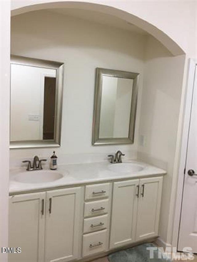 725 Edgewater Ridge Court Apex, NC 27523 - Photo 11 of 22 a bathroom with mirror sink and vanity