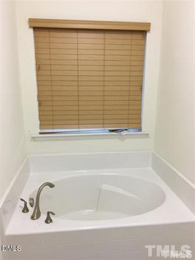 725 Edgewater Ridge Court Apex, NC 27523 - Photo 13 of 22 a bathroom with a bathtub