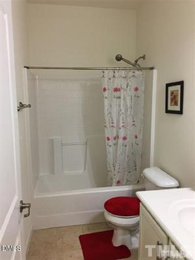 725 Edgewater Ridge Court Apex, NC 27523 - Photo 15 of 22 a bathroom with a shower and a toilet