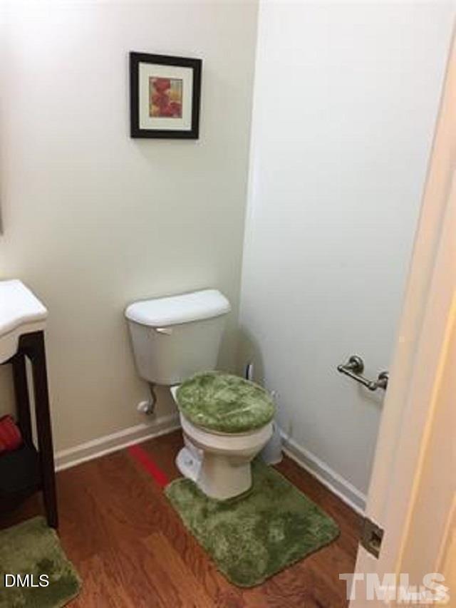 725 Edgewater Ridge Court Apex, NC 27523 - Photo 16 of 22 a bathroom with a toilet and a mirror