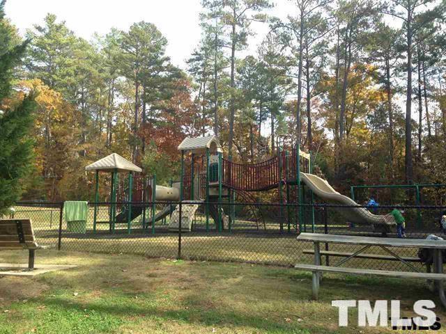 725 Edgewater Ridge Court Apex, NC 27523 - Photo 21 of 22 a view of a park with swings and slides