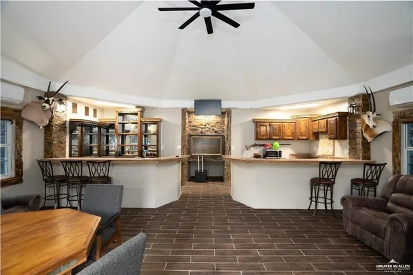a kitchen with a table chairs refrigerator and microwave