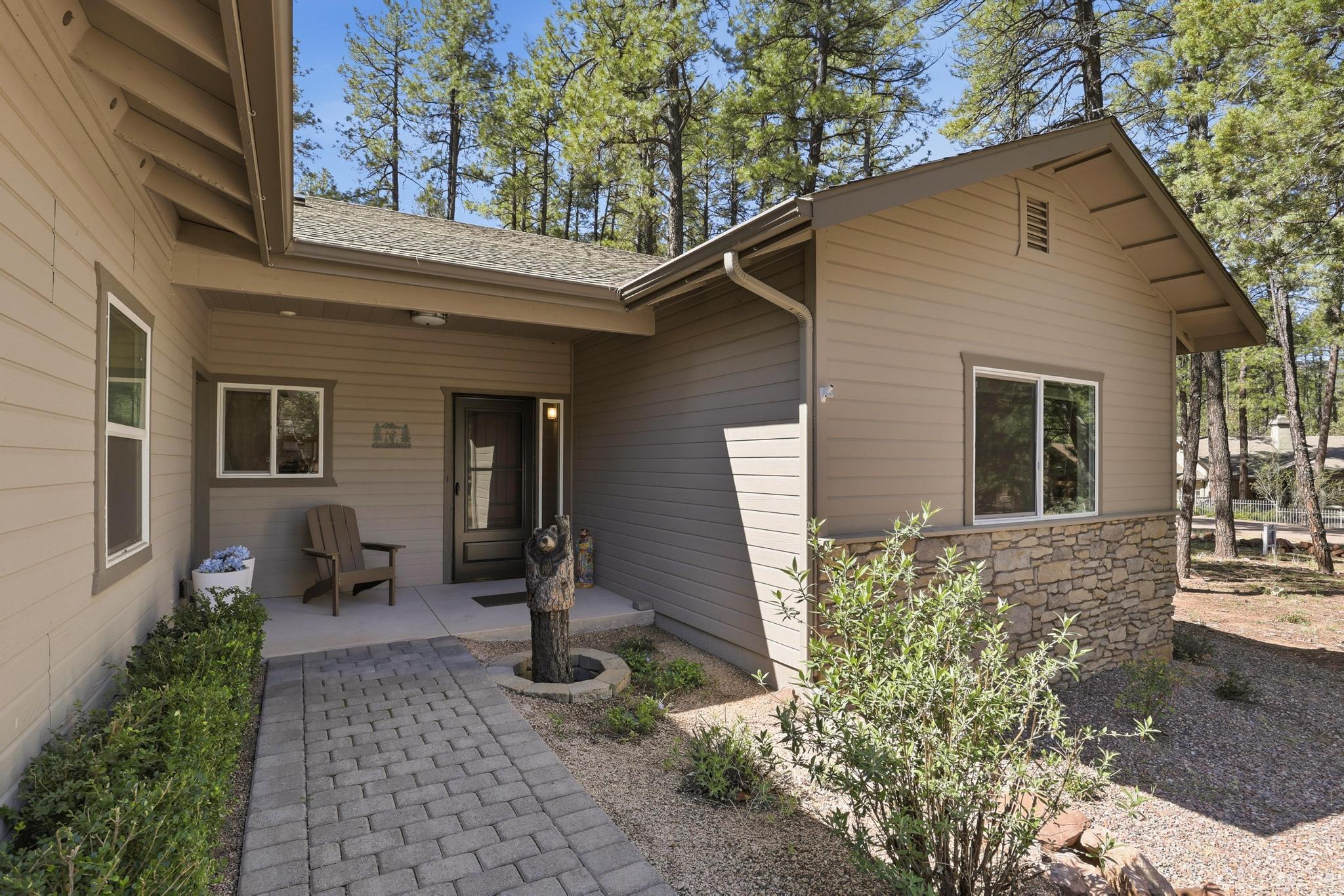 5501 Solitude Trail Loop Pine, AZ 85544 - Photo 4 of 27 a front view of a house with garden