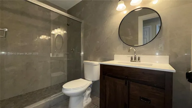a bathroom with a sink toilet and a mirror