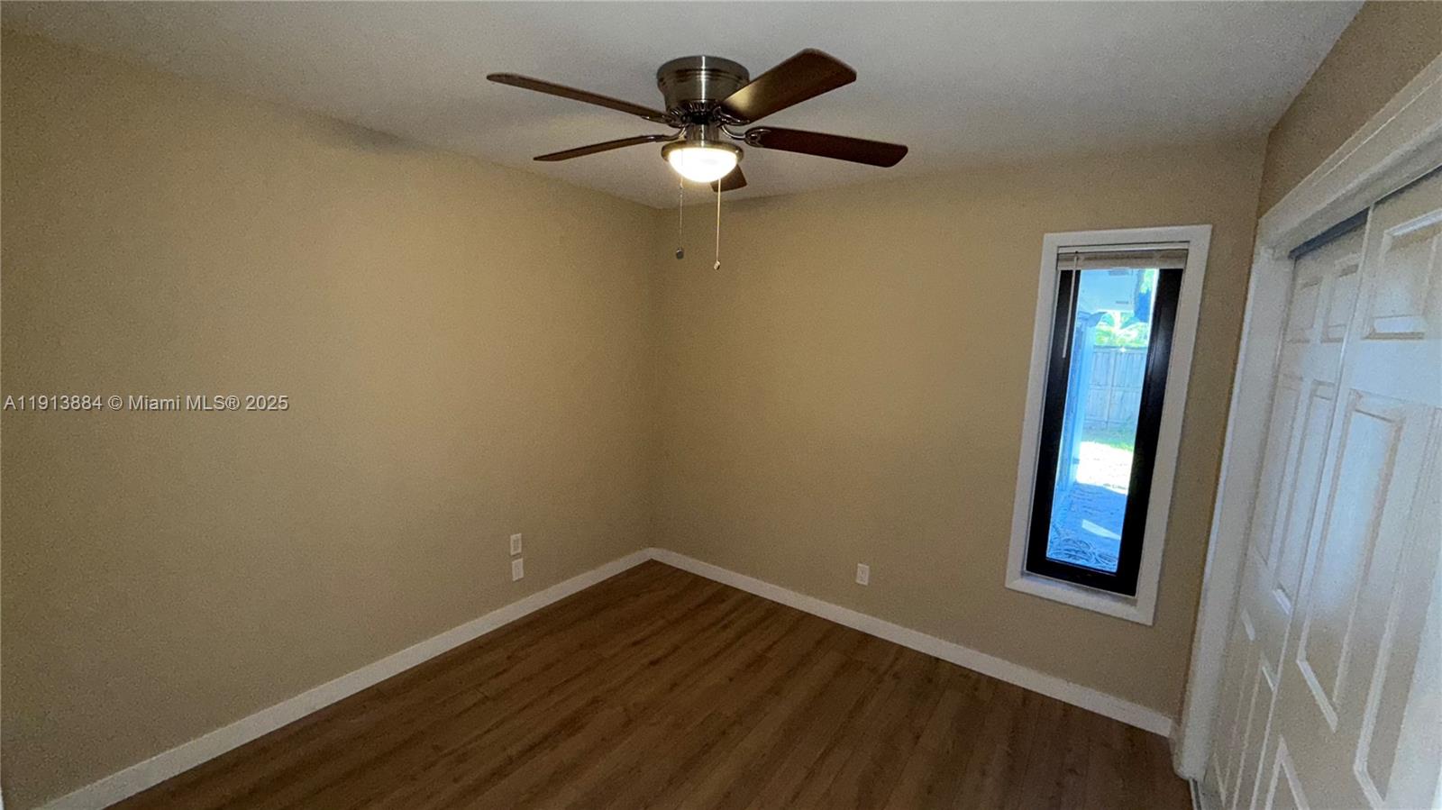 6625 Southwest 49th Street, Unit 2W Davie, FL 33314 - Photo 16 of 33 an empty room with wooden floor and fan