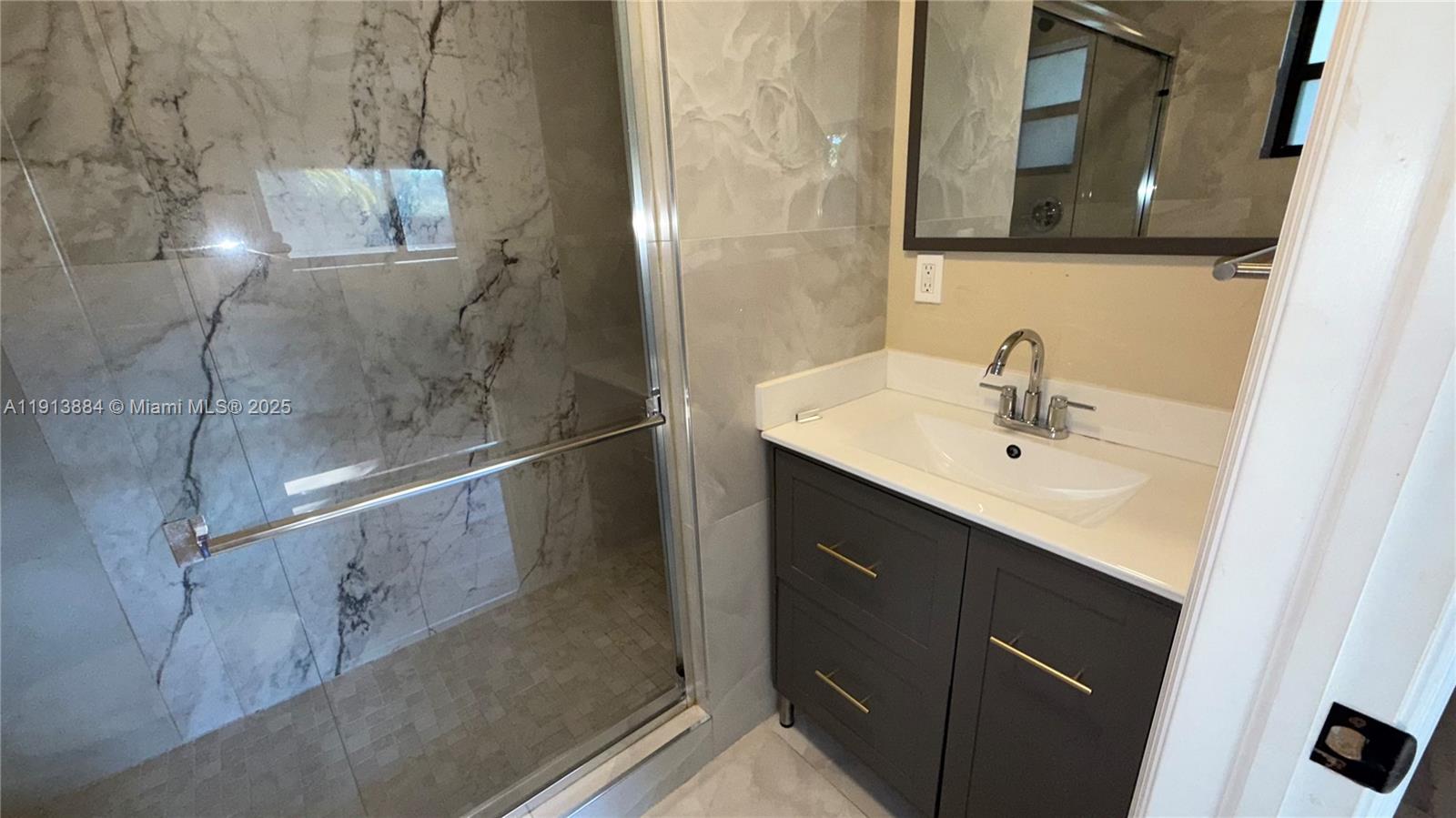 6625 Southwest 49th Street, Unit 2W Davie, FL 33314 - Photo 24 of 33 a bathroom with a sink and mirror