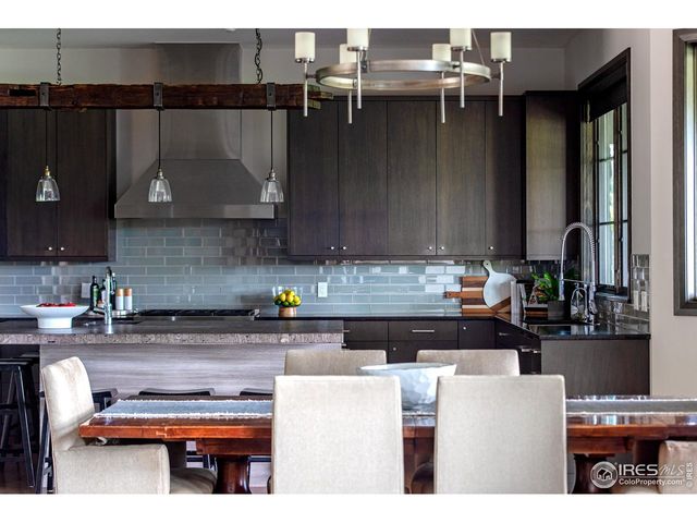 a kitchen with a refrigerator and a stove