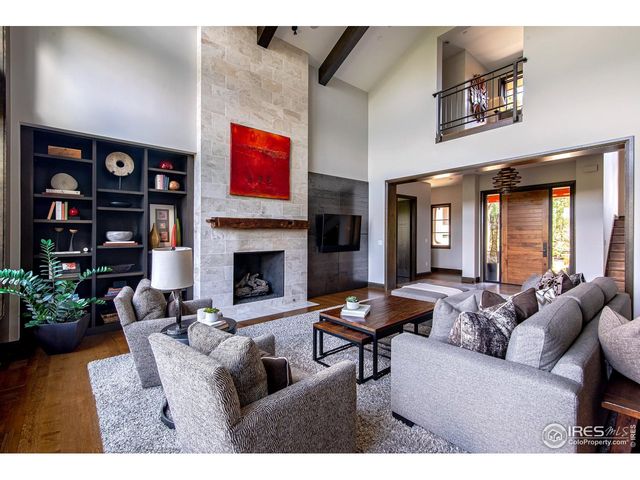 a living room with furniture a bookshelf and a fireplace