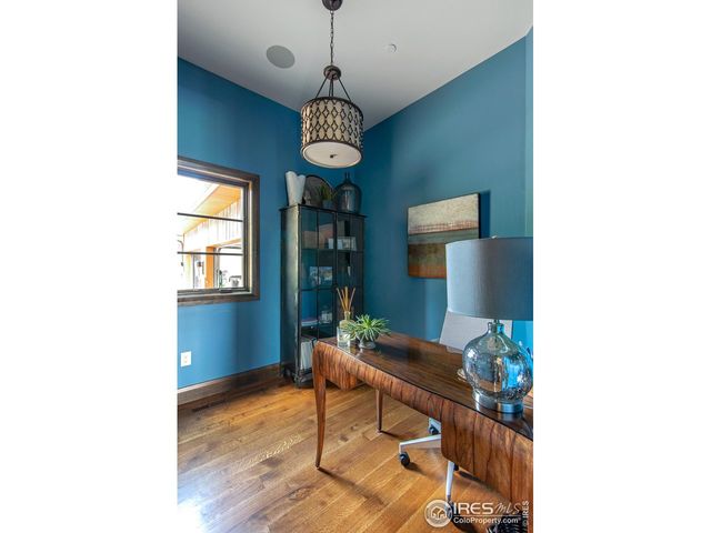 a view of a dining room with a table and chairs