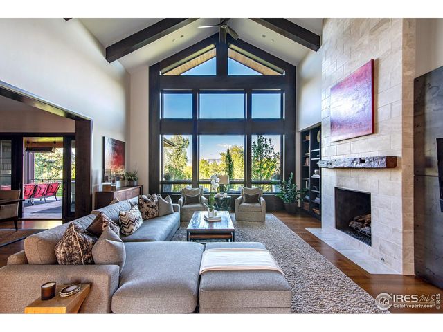 a living room with furniture fireplace and a large window