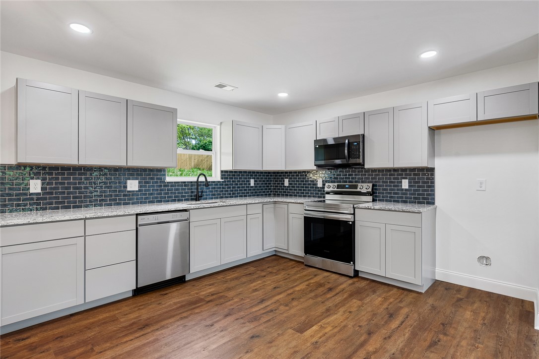 1215 East Whitner Street Anderson, SC 29624 - Photo 11 of 30 This newly renovated kitchen features sleek countertops, modern appliances, and ample cabinet space.