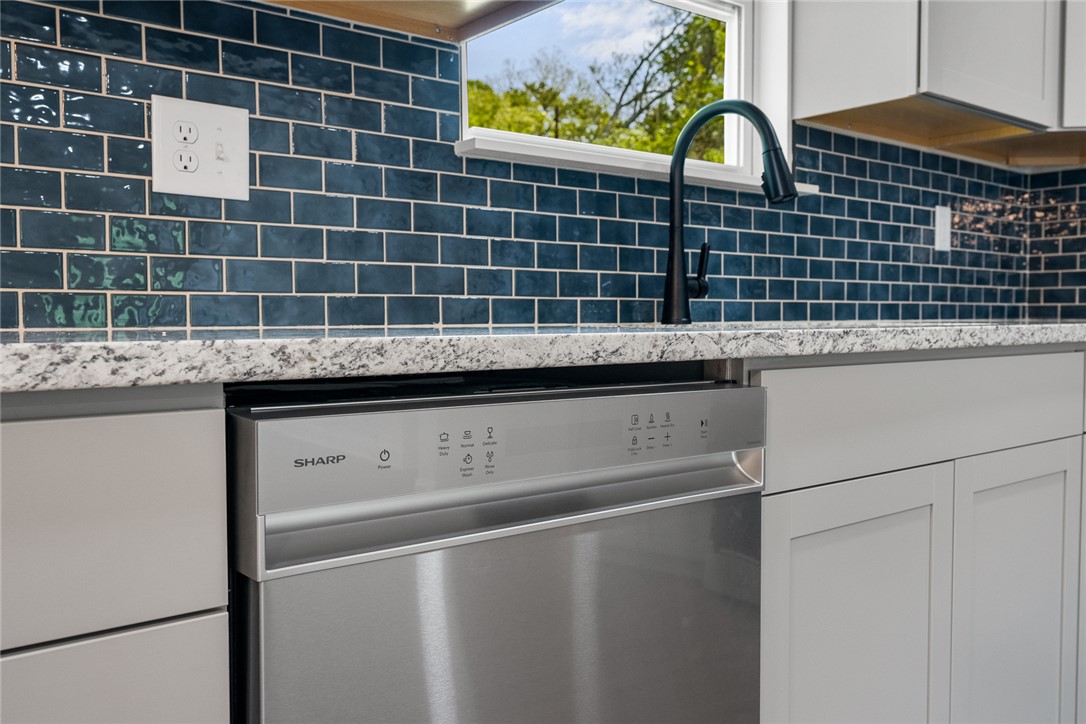 1215 East Whitner Street Anderson, SC 29624 - Photo 15 of 30 This modern kitchen features stylish subway tile backsplash and sleek stainless steel appliances.