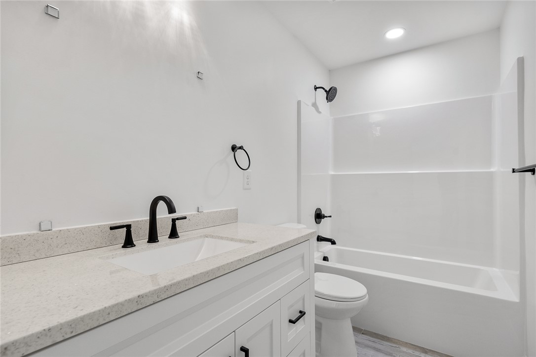 1215 East Whitner Street Anderson, SC 29624 - Photo 21 of 30 This clean and bright bathroom features a modern vanity with elegant fixtures.