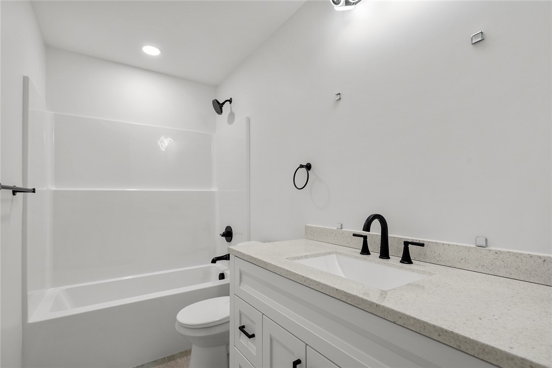 1215 East Whitner Street Anderson, SC 29624 - Photo 24 of 30 This modern bathroom features a sleek vanity and a classic tub, designed for everyday comfort.