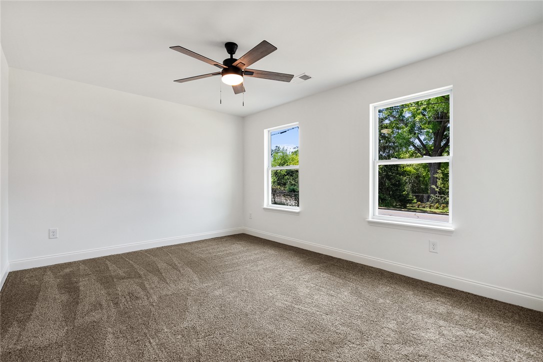1215 East Whitner Street Anderson, SC 29624 - Photo 25 of 30 This bright and airy room offers comfortable carpeting and scenic outdoor views.