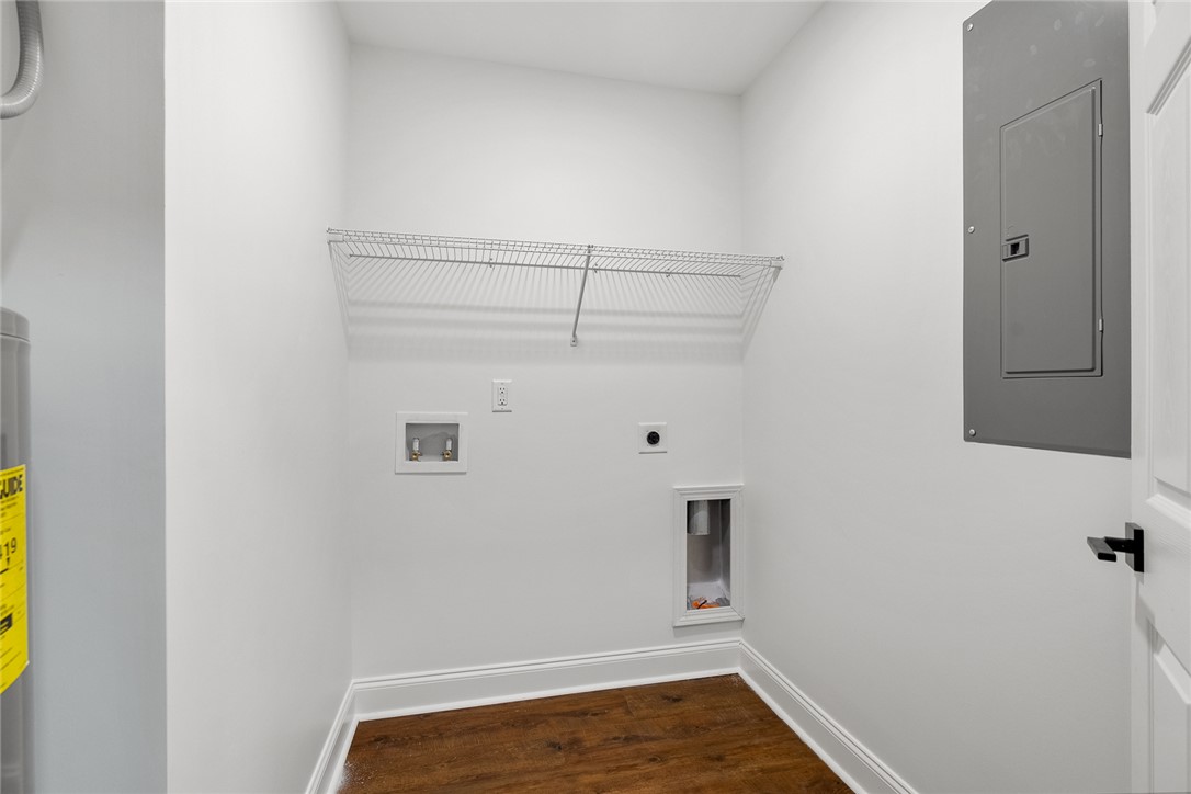 1215 East Whitner Street Anderson, SC 29624 - Photo 26 of 30 This dedicated utility space offers convenient hookups for laundry appliances and practical wire shelving.