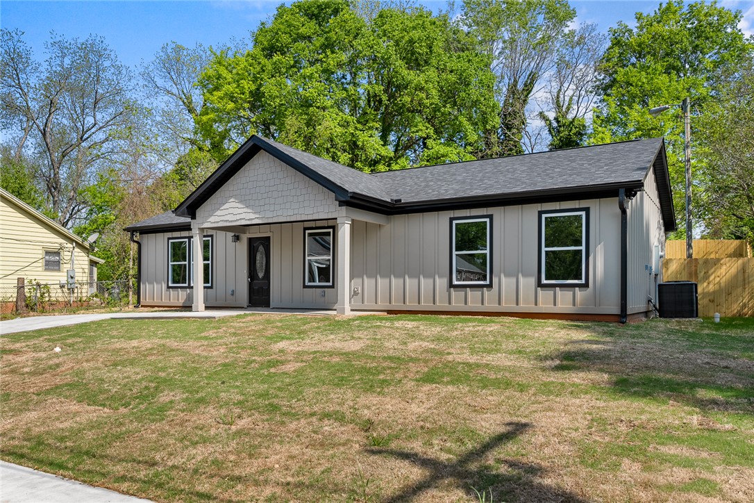 1215 East Whitner Street Anderson, SC 29624 - Photo 3 of 30 This newly constructed home boasts modern exterior finishes and a welcoming covered porch.