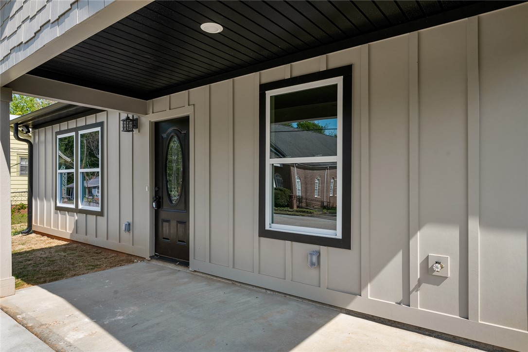 1215 East Whitner Street Anderson, SC 29624 - Photo 5 of 30 This inviting exterior features a covered porch, modern windows, and durable siding for curb appeal.