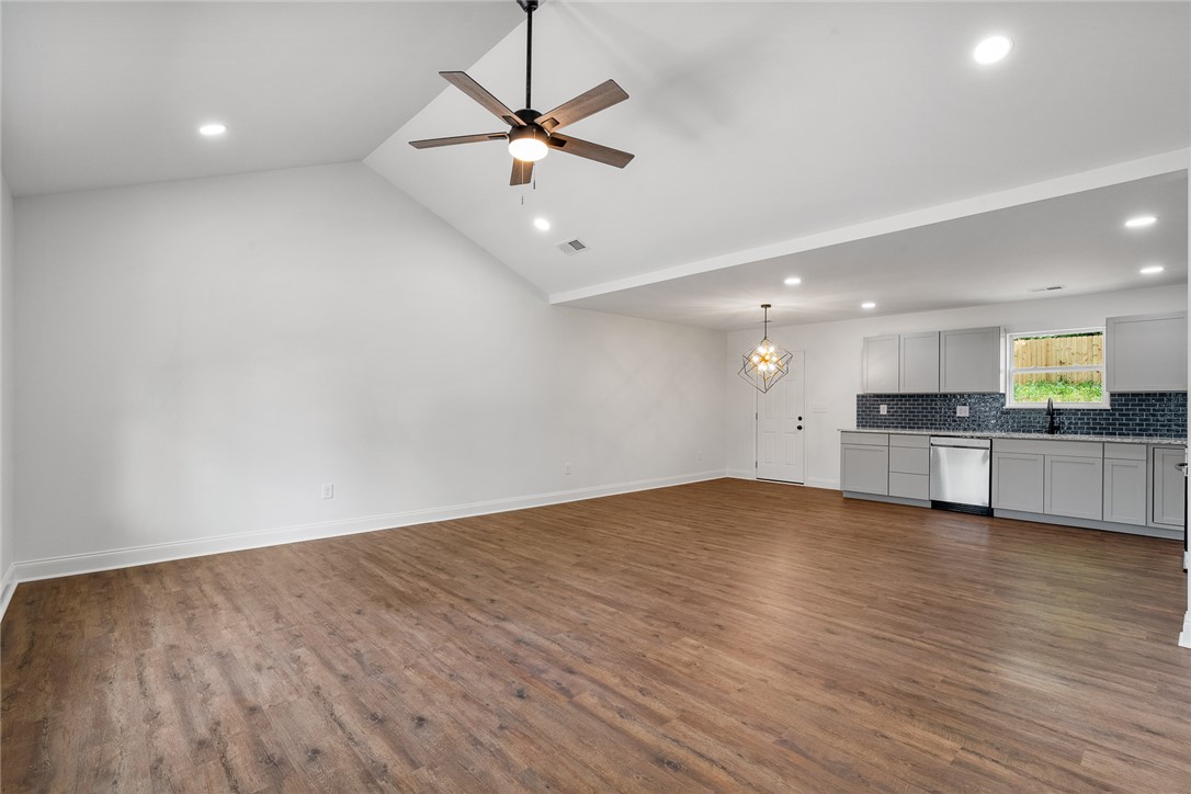 1215 East Whitner Street Anderson, SC 29624 - Photo 6 of 30 This bright, open-concept living space features warm flooring, modern kitchen appliances, and ample natural light.