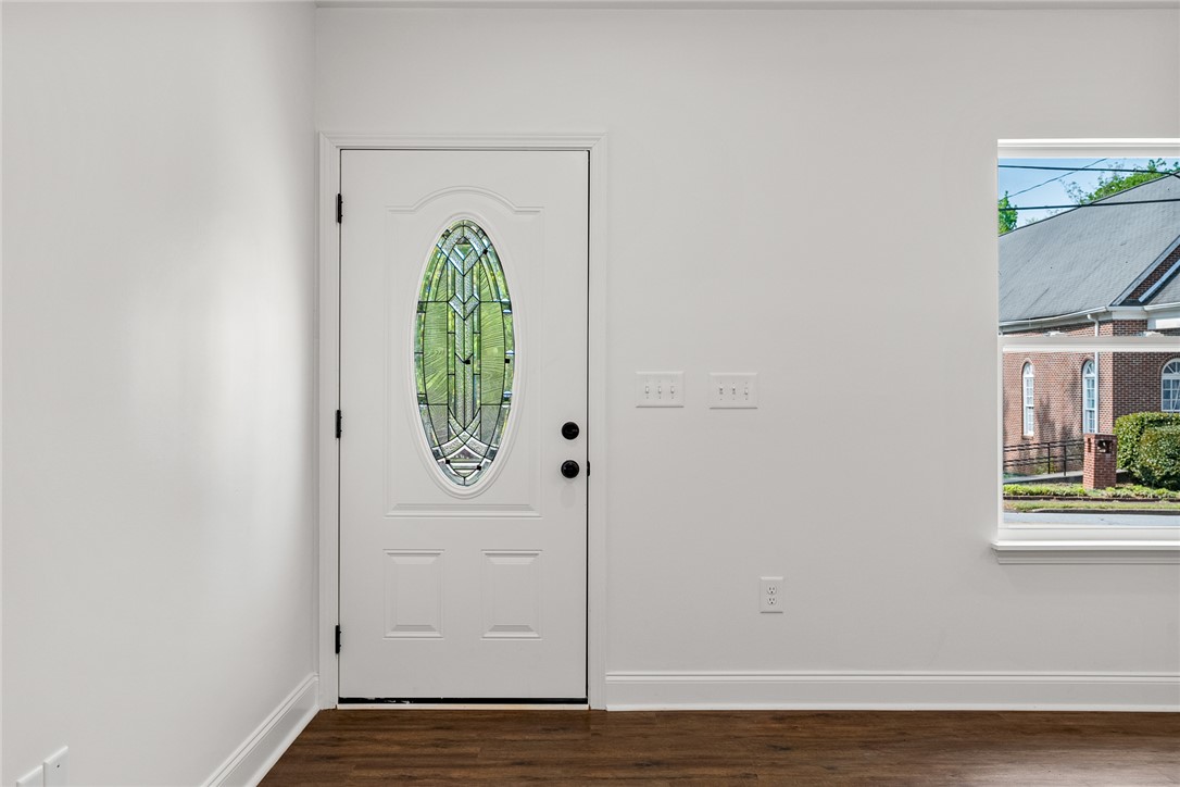 1215 East Whitner Street Anderson, SC 29624 - Photo 7 of 30 This inviting entry features hardwood flooring and a stylish door with decorative glass.