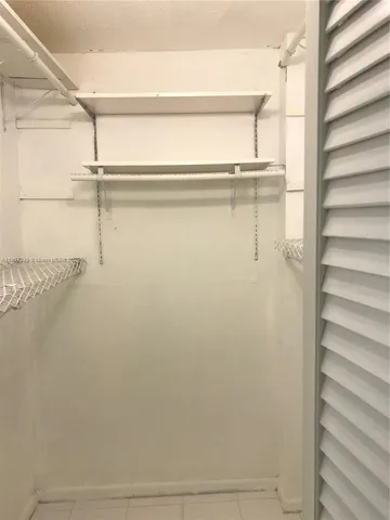 a white toilet and tub sitting next to a bathroom sink